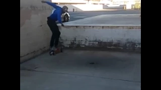 Skateboarder falls down wall