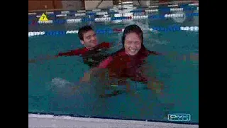 UK dating show with girl in shorty wetsuit in pool