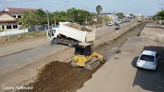 First foundation nation road! CAT Dozer pushing stone with group dump trucks unloading