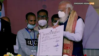 PM Narendra Modi distributes land allotment certificates to the people of Assam.
