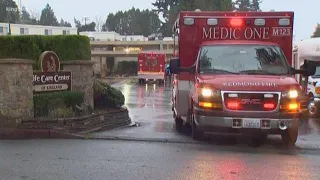 Ambulances arrive at Life Care Center in Kirkland to transport patients