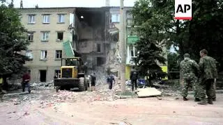 Officials say an airstrike demolished an apartment block in eastern Ukraine on Tuesday, killing at l