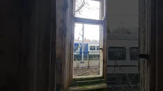 View of train from an abandoned railway station window.