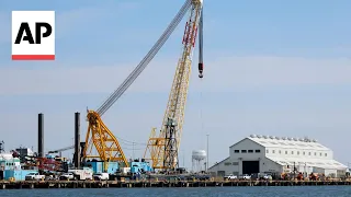 Floating crane arrives at wreckage of Baltimore's collapsed bridge