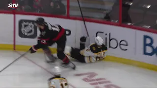 Mike Reilly flies to the boards after a big hit by Zach Sanford