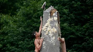 U.S. Naval Academy plebes attempt annual greased climb