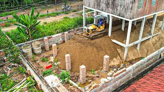 The best project land filling up the fence foundation with a bulldozer and soil pushing operator.