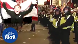 England fans react wildly and climb lamp posts as street party erupts after Denmark win