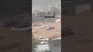 Cars carried away by Beijing flood