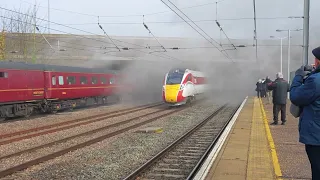 Black 5 44871 departs Huntingdon Station in full steam as an LNER Azuma makes a sudden appearance