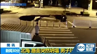 WATCH: Man looking down at phone falls into hole