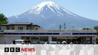 Japanese town blocks iconic Mount Fuji view to deter tourists | BBC News