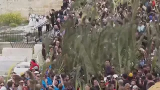 Thousands of faithful attend Palm Sunday celebrations in Jerusalem against a backdrop of war