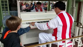 Jim Omohundro at Disney World's Magic Kingdom Helping Some Kids Play A Song