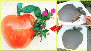 An apple-shaped flower pot made of cement to decorate your garden and backyard