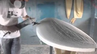 Hand shaping a surfboard from a blank