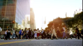 crowd of people walking on busy city street at REJNV6S