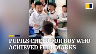 Pupils cheer for boy who achieved full marks in China