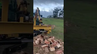 Cat mini excavator with log splitter attachment