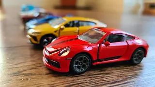 Tiny model cars being stopped by hand * - MyModelCarCollection