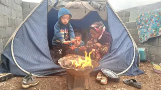 Heavy rain: the continuous effort of a brave mother to warm her children in the tent