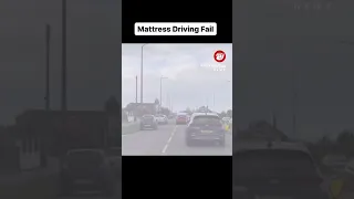 Driver and passenger cling onto a mattress as it sits on the roof of a moving car #shorts