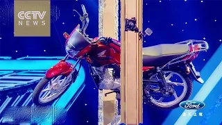 Impossible Challenge: Man balances motorcycle on suspended picture frame