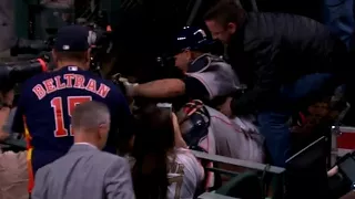 Brian McCann tumbles over the wall as he nearly comes up with the catch