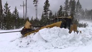 Plowing snow from roads in the spring in Yellowstone National Park