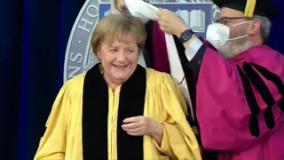 Merkel wrestles with robes at degree ceremony