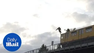 Reckless teen jumps from the top of a moving train into a canal - Daily Mail