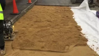 Compacting laying sand for block driveway paving wacker