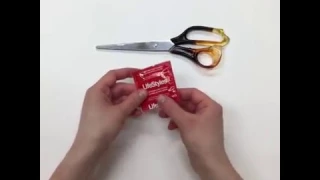 Make a sheet of latex out of a condom with scissors