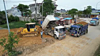 New side working with bulldozer pushing soil filling the lake with team work 5ton truck loading soil