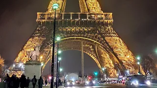 Eiffel Tower night lights and spotlights at the top