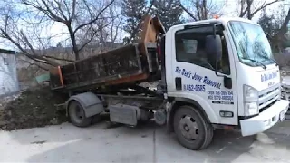 Isuzu mini roll-off truck dumping 5 yards of dirt - Big Ben's Junk Removal