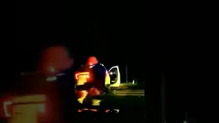 Police car hit by train with suspect handcuffed in the back.