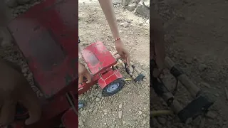 Mahindra tractor toy on small farm