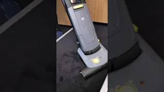 Karcher vacuum cleaner with rotating brush testing on dirty concert hall carpet model CV 38/2 adv