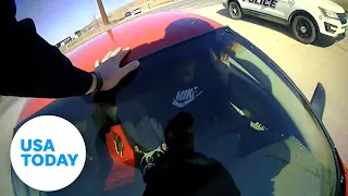 Officer clings to the hood of suspects fleeing car, new video shows | USA TODAY