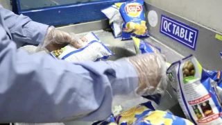 Quality Control checks packaging at Pepsico