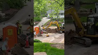 Construction worker fills young boy's toy truck
