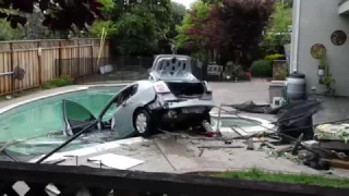 Whoops! Car ends up in a swimming pool after driver falls asleep