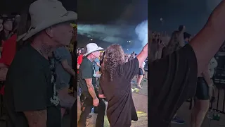 Kirk Hammett & James Hetfield playing air guitar at Power Trip during the Judas Priest set