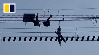 Tourists hanging upside down after suspension bridge flipped