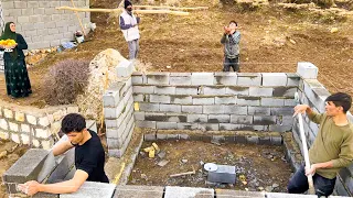 "Building Our Winter Fortress: Amir and Family Raise the Walls of Their Block House Day by Day"