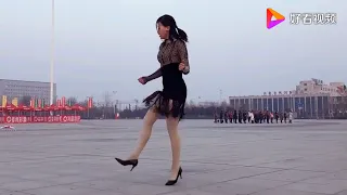 Qingqing dances in high heels to a song by Britney Spears