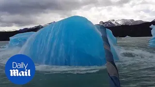 Extraordinary moment massive iceberg explodes next to boat