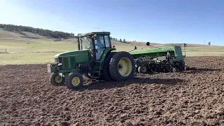 Deere 7700 pulling 750 no-till drill