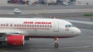 Air India Airbus A320-214 Reg. VT-EDC Taxiing Across a wet Apron at Delhi IGI Airport, India